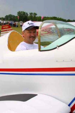 Bert Thibodeaux sits in his Fisher Flying Products Avenger single place all wood aircraft.